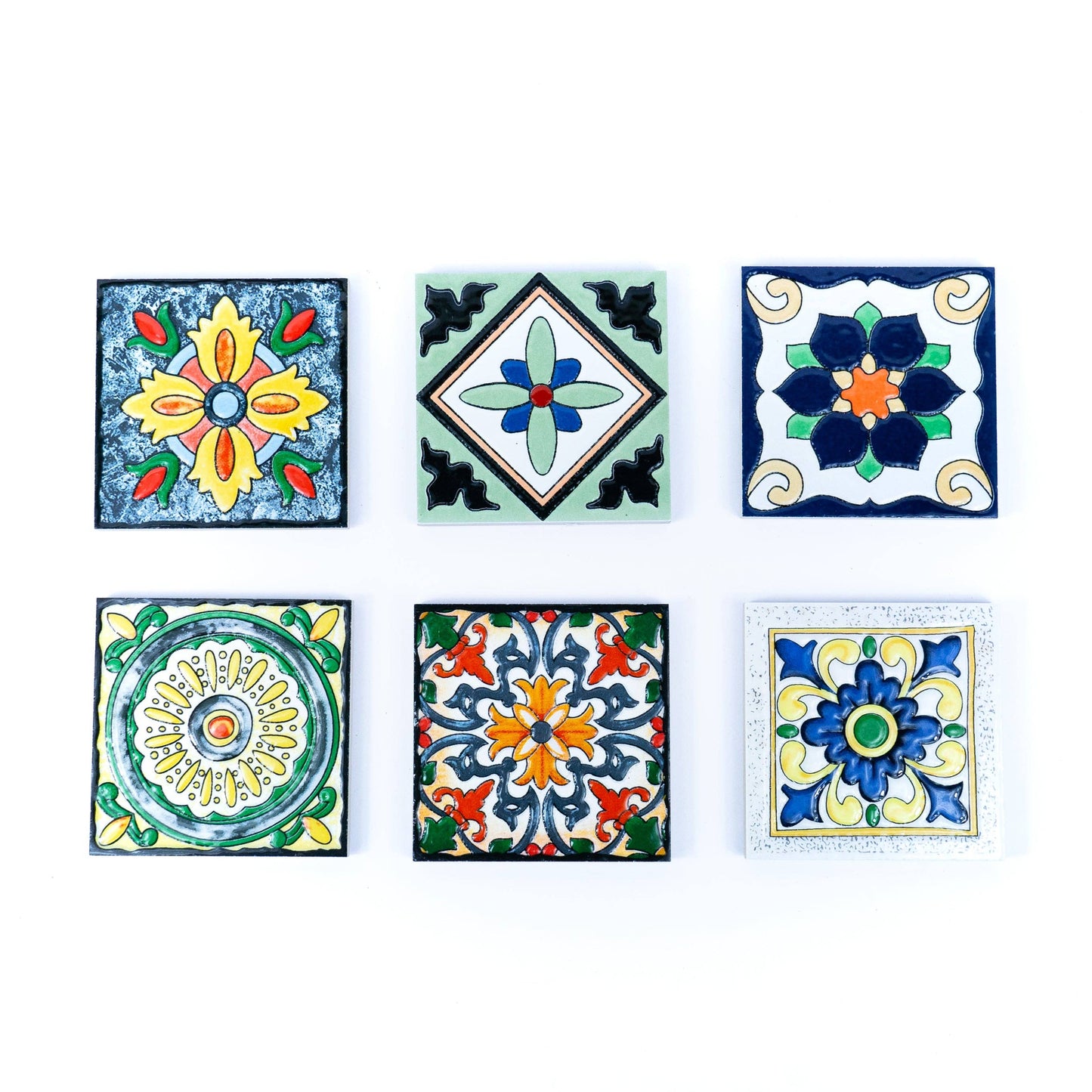 The Tile-Inspired Ceramic & Cork Coasters - Set of 6 by Meninas Bonitas Cork features six unique coasters with colorful floral and geometric patterns in blue, yellow, green, orange, and red. Each coaster combines vibrant azulejo-inspired designs.