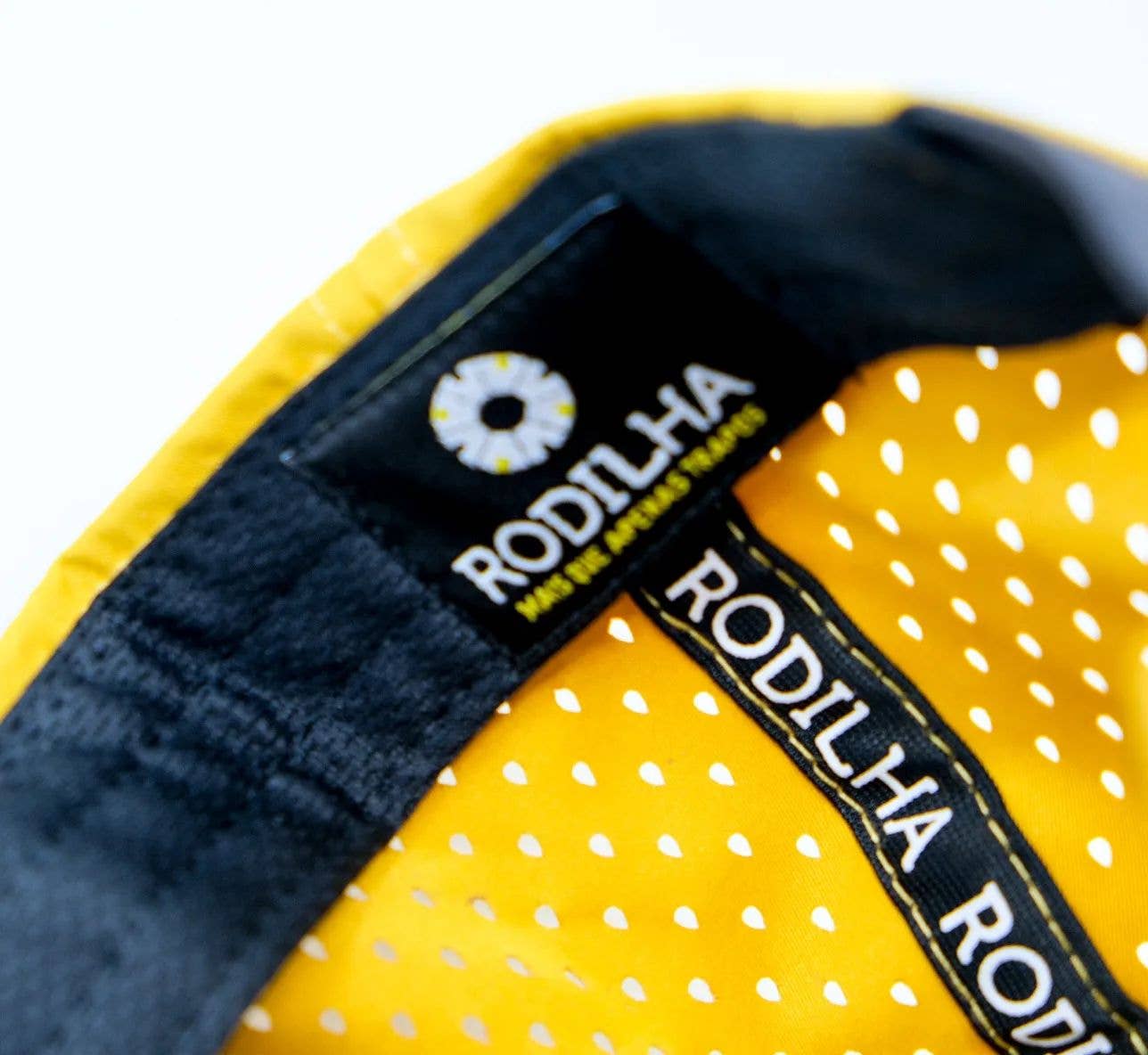 Close-up of the Cap-Sardines and Tiles (Yellow and Black) by Rodilha, showing yellow fabric with white polka dots, black trim, a distinct “RODILHA” label, circular logo, and yellow tagline, inspired by Portuguese heritage.