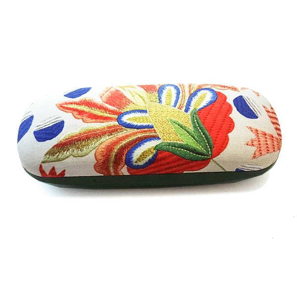 The Terra Lusa Castelo Branco Embroidery Glasses Case is a handmade natural silk linen case, featuring a vibrant floral pattern in red, yellow, green, blue, and orange on white, inspired by traditional Portuguese embroidery.