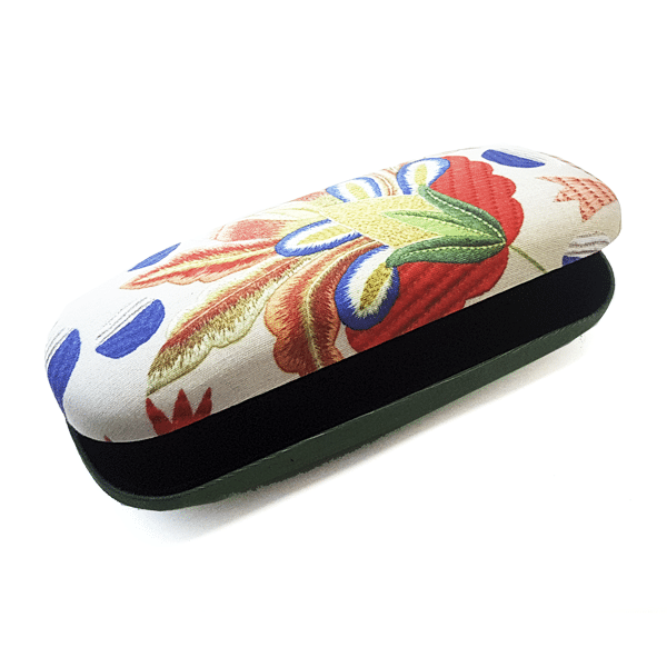 The Castelo Branco Embroidery Glasses Case by Terra Lusa is a rectangular handmade case crafted from natural silk linen, featuring a colorful floral design inspired by traditional embroidery and a black interior on a vibrant white background.