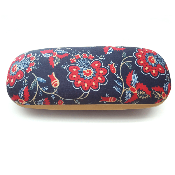 The “Chita” Glasses Case by Terra Lusa features a navy background with red and white floral patterns inspired by Portuguese heritage and tan edges, shown from a top view.