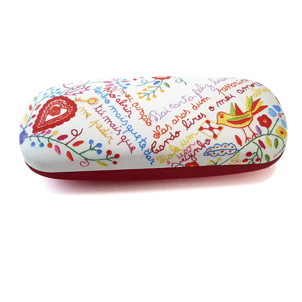 The Terra Lusa "Lovers" Handkerchiefs Glasses Case features floral patterns, a heart, bird, and multicolored handwritten text on white with a red base, inspired by Portuguese embroidery.