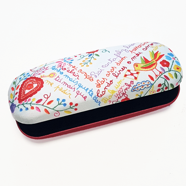 The "Lovers" Handkerchiefs Glasses Case by Terra Lusa features handwritten text and playful drawings of flowers, leaves, and a bird on a white background, inspired by the charm of Portuguese embroidery.