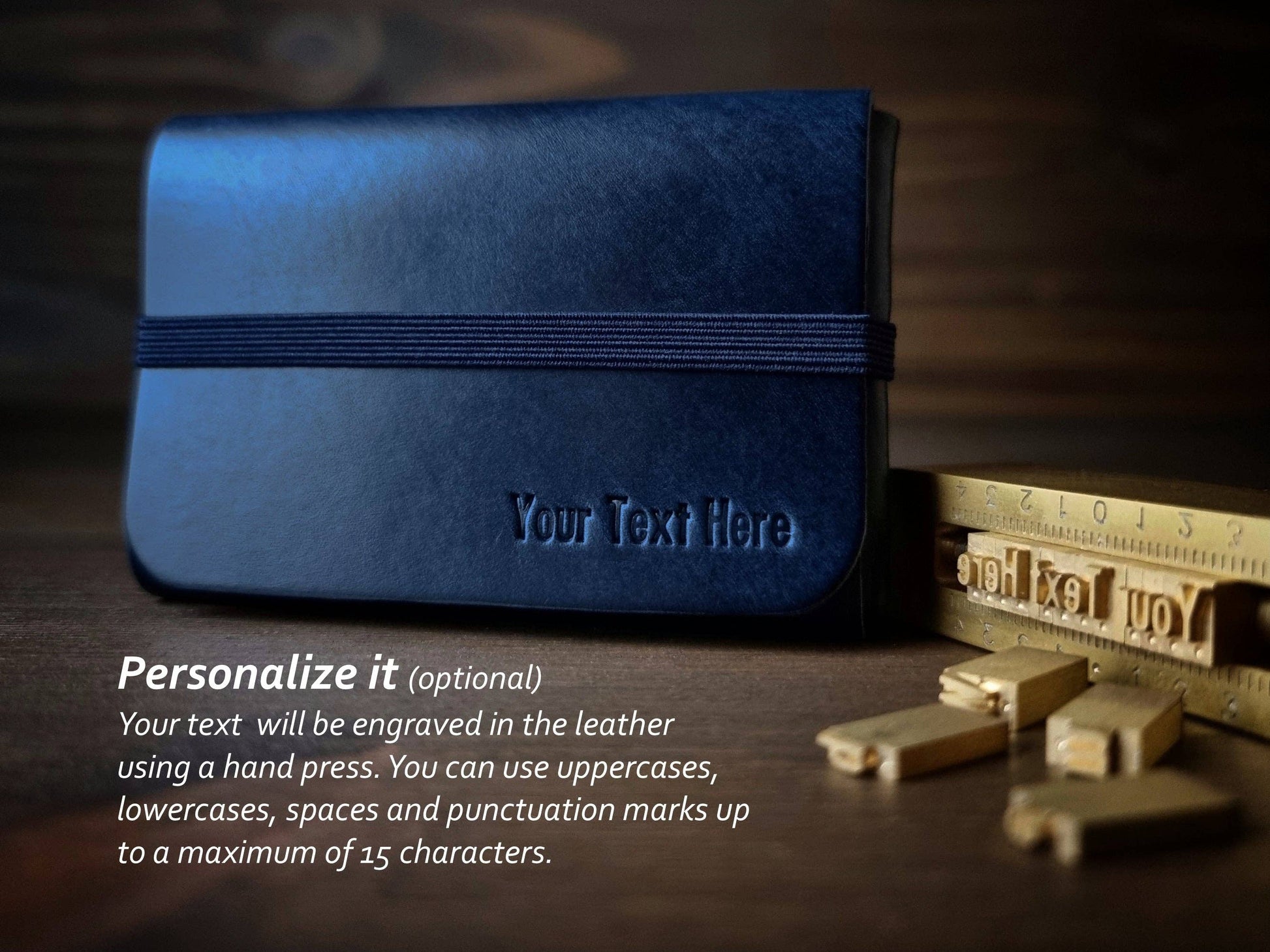 The Singular Leather Marine Blue Leather Wallet is crafted from genuine leather, features brass letter stamps, allows up to 15 engraved characters for personalization, and includes RFID protection for security.
