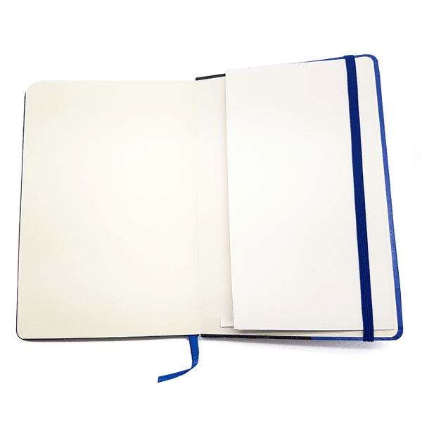 An open Terra Lusa Fado Notebook with a blue ribbon bookmark and blue elastic band holds blank white papers inside, partially covering the right page and celebrating Portuguese Cultural Heritage.