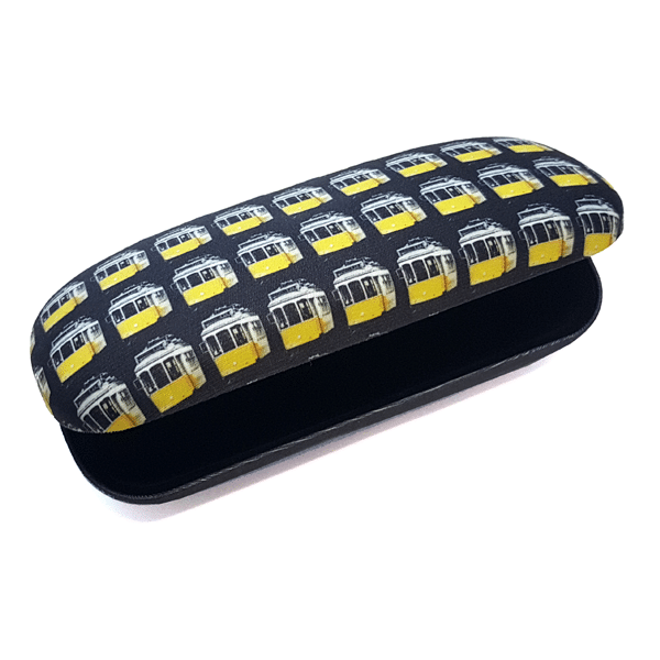 The "Tram" Glasses Case by Terra Lusa features yellow and white vintage trams on a black background, celebrating Portugal’s culture. The case is open, showing its black interior.