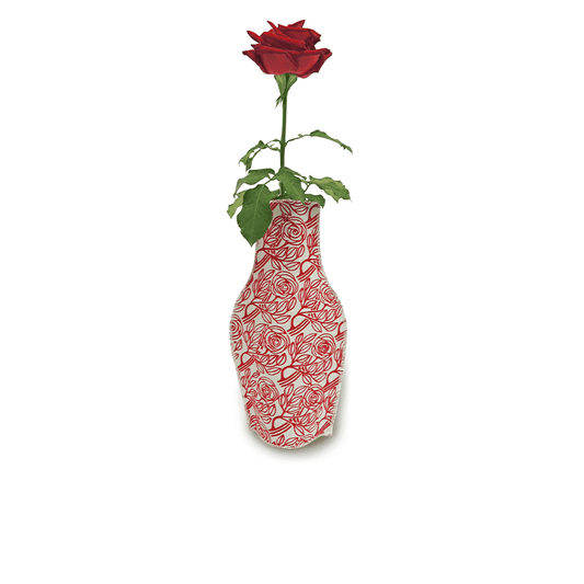 A single red rose with green leaves is displayed in the Born Roses Cotton Flower Vase by Barceloning, an eco-friendly piece inspired by Barcelona modernist decor, featuring a red rose pattern on white.