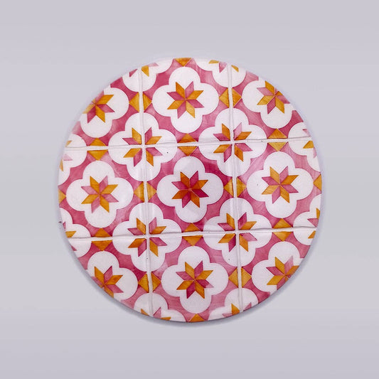 ceramic trivet with red and yellow motif