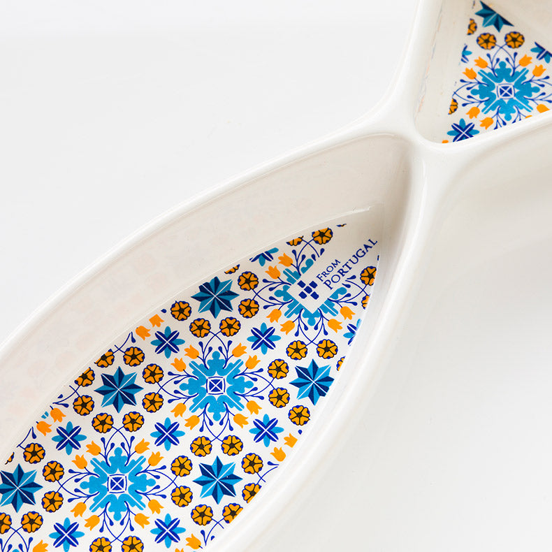The ObjectoAnonimo Olives serve 'Sardine 16' Dish - ref 695 is a white Portuguese ceramic plate with blue, yellow, and orange geometric and floral tile patterns, two connected ovals, and a "Made in Portugal" label.