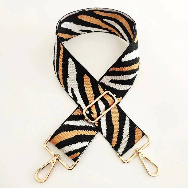 Gold clip ends on zebra patterned strap, universal clips for most bags.