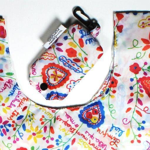 The Lovers’ Handkerchiefs Eco Shopper by Terra Lusa includes a reusable bag and matching pouch with a vibrant floral and heart design. The pouch features a black snap and clip—ideal for chic, sustainable shopping.