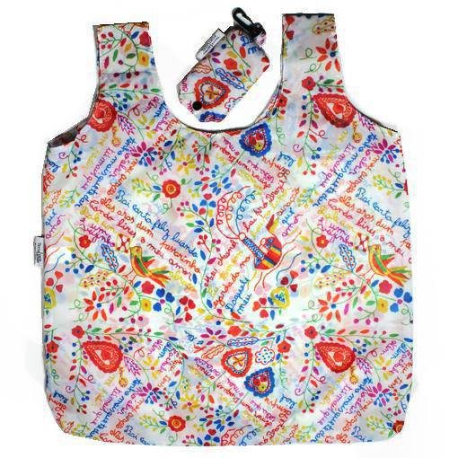 The Lovers’ Handkerchiefs Eco Shopper by Terra Lusa is a reusable shopping bag with a matching pouch, featuring birds, hearts, flowers, and charming phrases on crisp white, inspired by traditional handkerchief patterns.