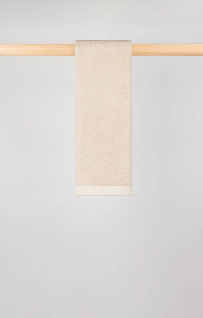 Image of Natural Torres Novas X Zero hand towel hanging on a wooden rail