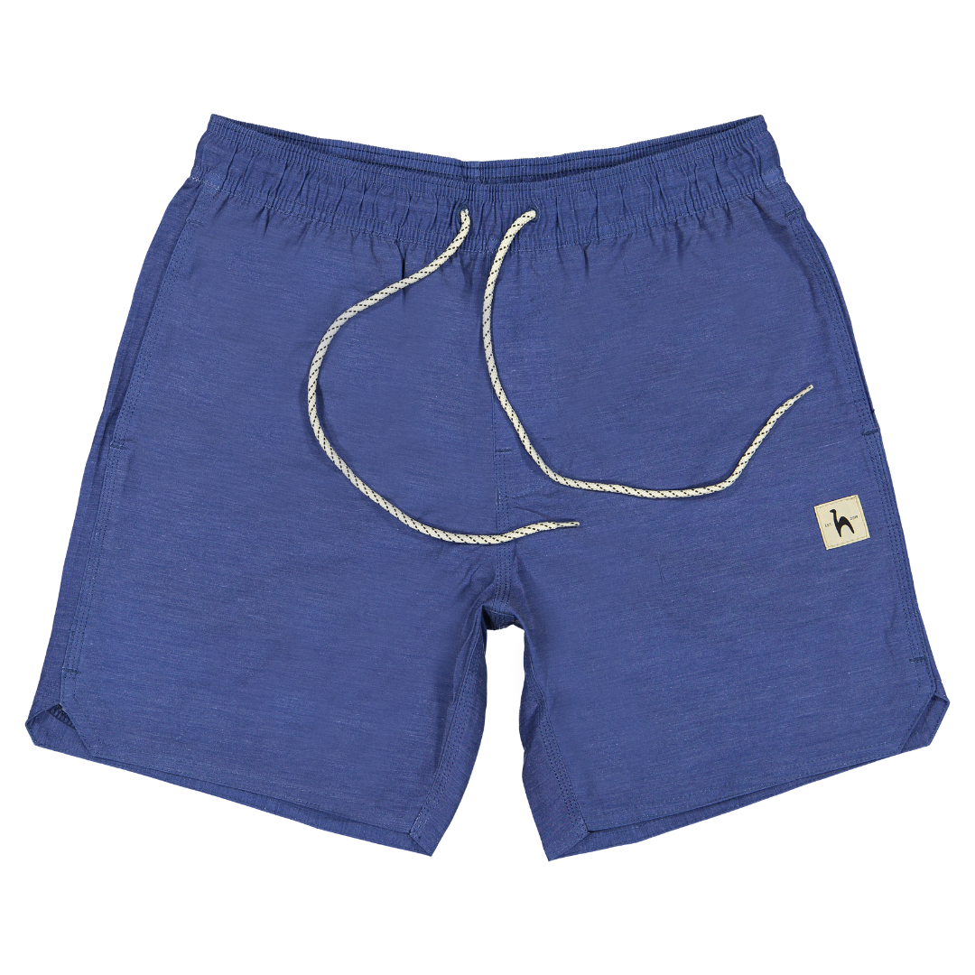 Futah’s blue Ericeira Volleys for men, featuring a white drawstring and a small beige patch with a bird logo on the left leg, made in Portugal and displayed flat on a white background.