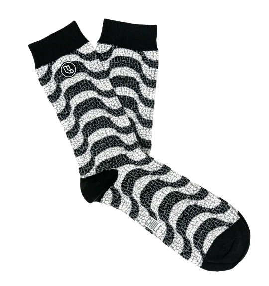 The Souvenir sock box by Iberica - Pretty things from Portugal includes black and white crew socks with a wavy zigzag pattern, solid black toes, heels, cuffs, and a small circular logo near the top of one sock.
