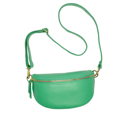 The Cassette Barcelona Leather Fanny Pack Crossbody Bag in green features a long adjustable strap and gold zipper closure, offering a stylish alternative to classic black bags—displayed against a white background.