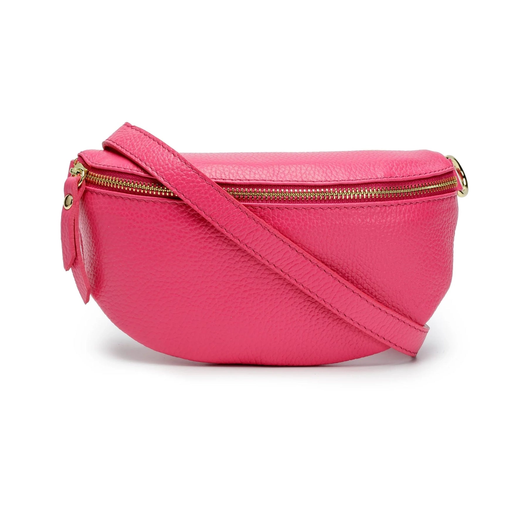 The Cassette Barcelona Leather Fanny Pack Crossbody Bag features bright pink textured leather, a gold zipper, and a matching adjustable strap for a playful update on the classic style, shown against a white background.