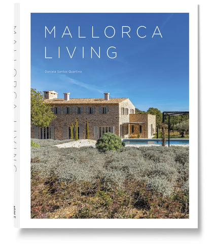 Book cover for Mallorca Living by Loft Publications features a rustic stone villa with green shutters and a pool, highlighting classic Mallorca architecture and Mediterranean villas under a clear blue sky.