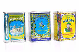 Three colorful 200ml Saloio Olive Oil tins by Machado, featuring ornate vintage Portuguese designs and labels, are displayed side by side on a white background, reflecting Portugals olive oil tradition.