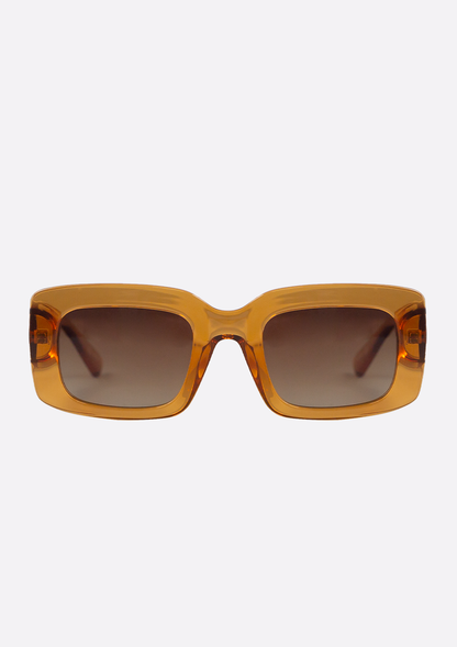 Oceanides Sunglasses (Polarized) - Ida Crystal Orange Brown: rectangular crystal orange-brown shades with thick, translucent amber frames and dark polarized UV400 lenses, displayed against a plain white background.