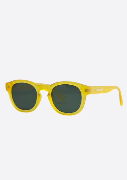 The Oceanides Atlas Yellow Frosted Sunglasses feature round dark lenses and a thick recycled plastic frame, shown at an angle against a plain white background.