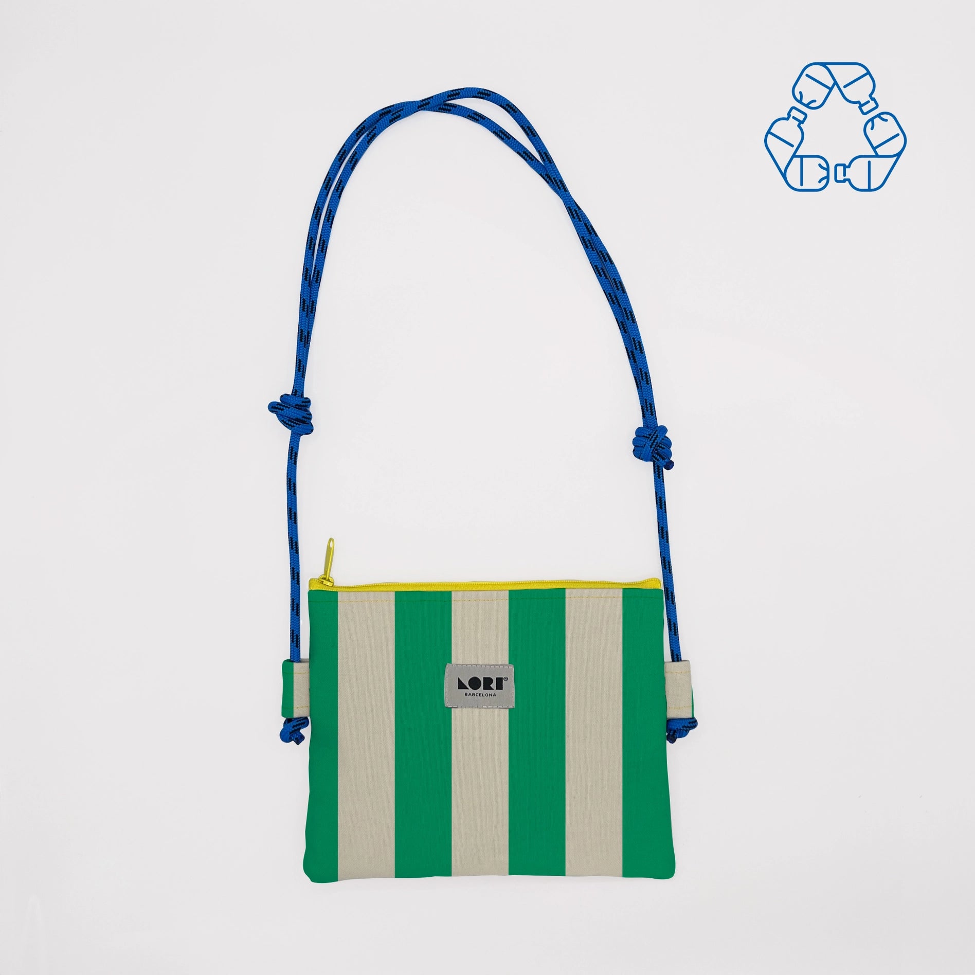 A small crossbody bag with vertical green and cream stripes, a blue braided shoulder strap, and a yellow zipper, shown on a light gray background with a blue recycling icon in the top right corner.