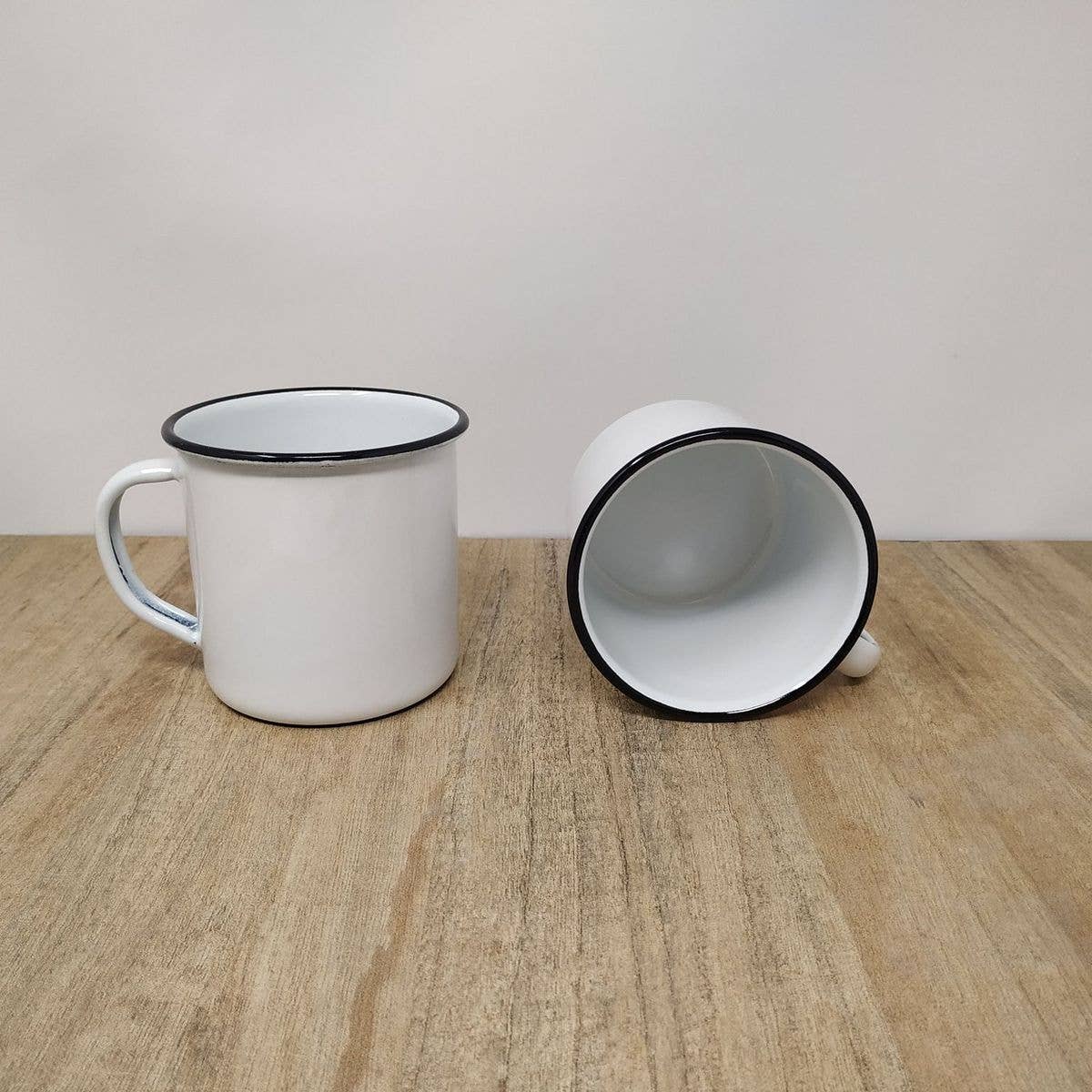 2 white enamel mugs