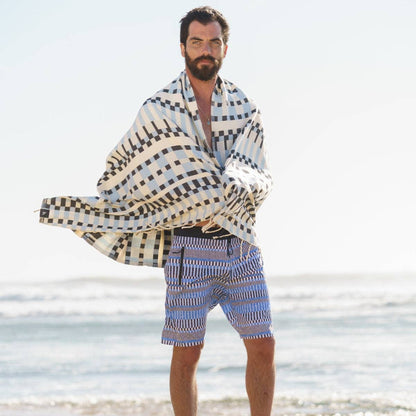 Man wearing Futah Guincho Blue boardshorts inspired by Portugal's Atlantic coast