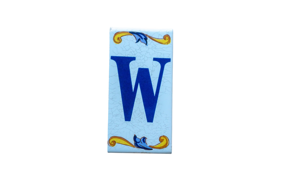 Lisa Croquets Letters – Ceramic House Letter Tile featuring a rectangular design with a blue letter W, accented by yellow and blue scrollwork patterns at the top and bottom.