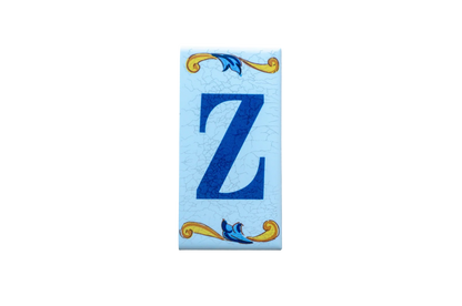 Lisa Croquets Letters – Ceramic House Letter Tiles featuring a dark blue letter Z on a light blue background, accented with yellow and blue scrollwork at the top and bottom.