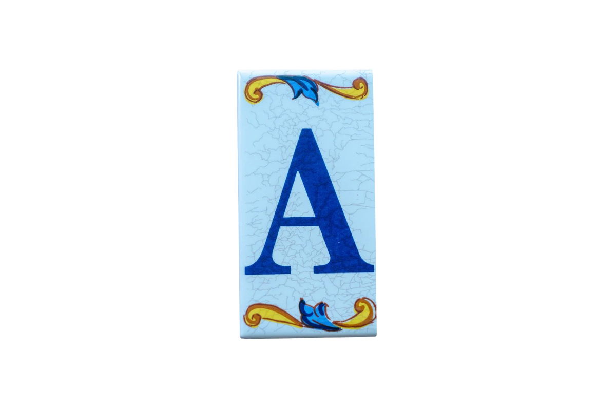 Lisa Croquets Letters – Ceramic House Letter Tiles rectangular Spanish tile, featuring a blue letter A on a light blue background with decorative scrollwork at the top and bottom.