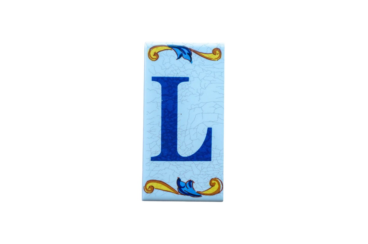 Lisa Croquets Letters – Ceramic House Letter Tile featuring the blue letter L on a light blue crackled background with decorative yellow and blue scrollwork.