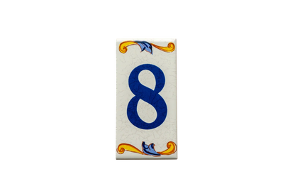 Rectangular Lisa Croquets Numbers ceramic house number tile featuring the number eight in blue, with handcrafted Spanish decorative blue and yellow scrollwork at the top and bottom.