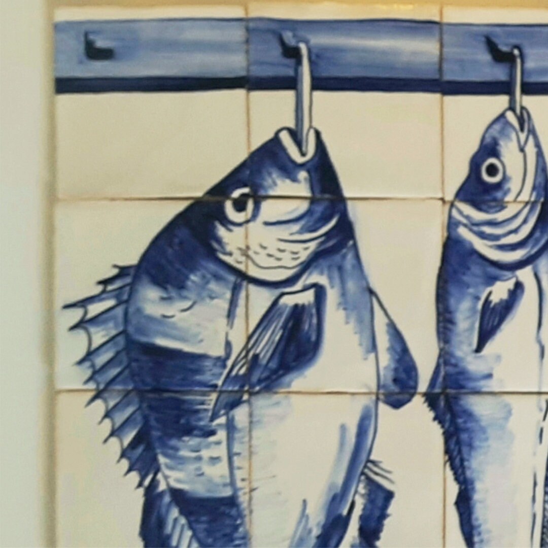 Handpainted Portuguese tile with a fish on a hook